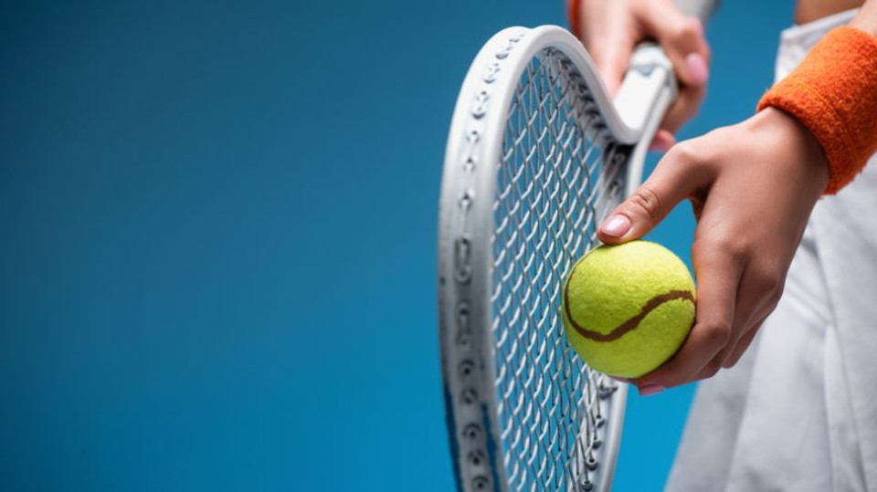Indoor tennis court, racket and ball on the floor, professional sports facility